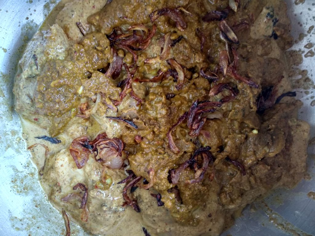 Fried Onions on Top of Marinaded Chicken in Pot