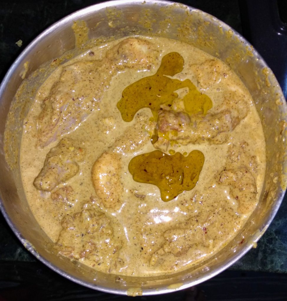 chicken marinade poured over chicken with oil for chicken dum biryani recipe