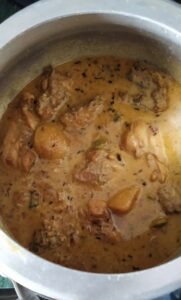 Chicken and its korma forms the first layer in pressure cooker