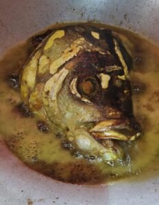 Frying the Fish Head for Pui Shaker Ghonto Chorchori